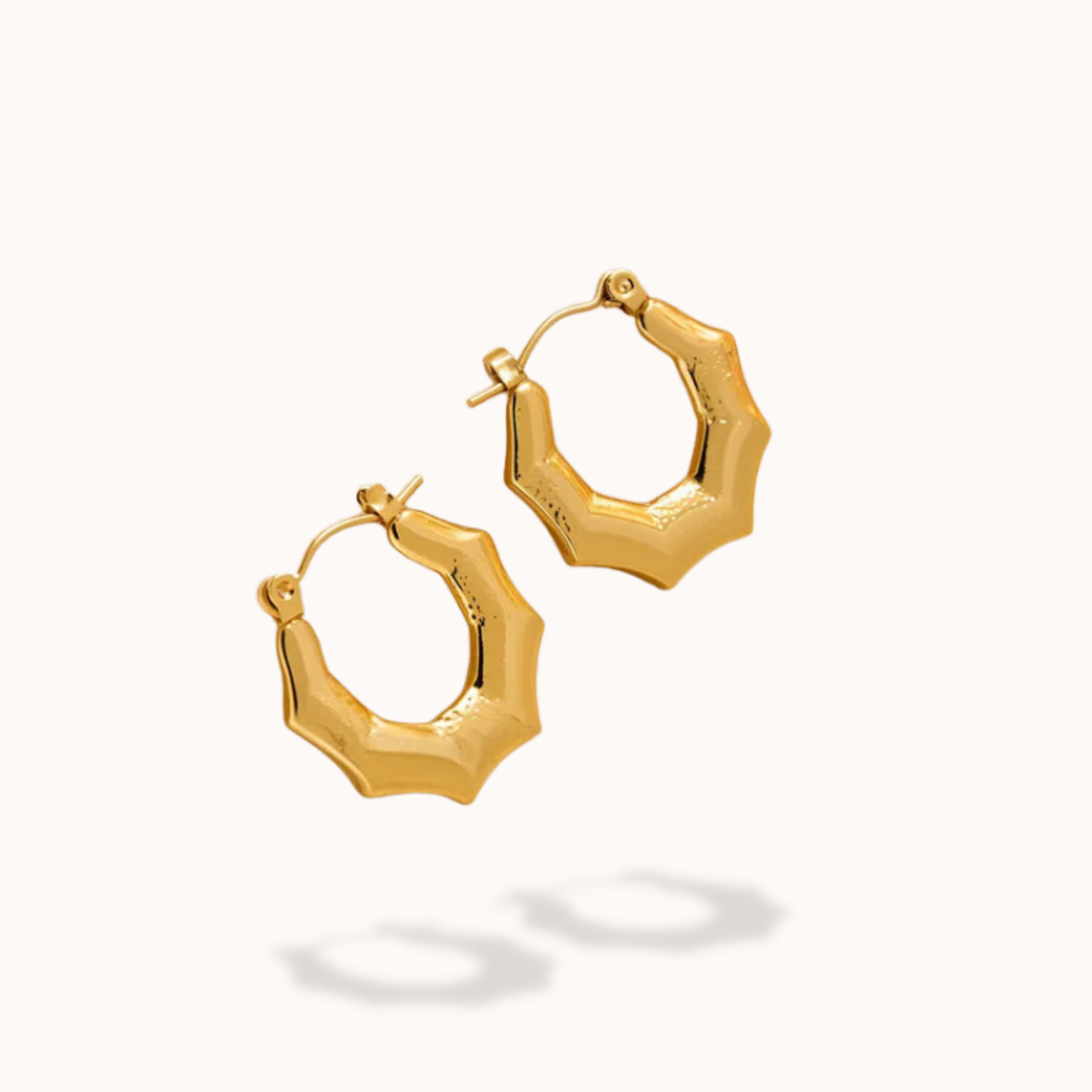 Gold hoop earrings on a white background