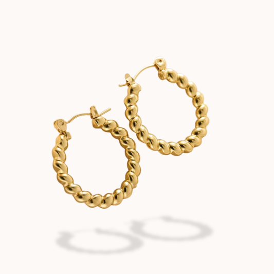 Gold hoop earrings on a white background
