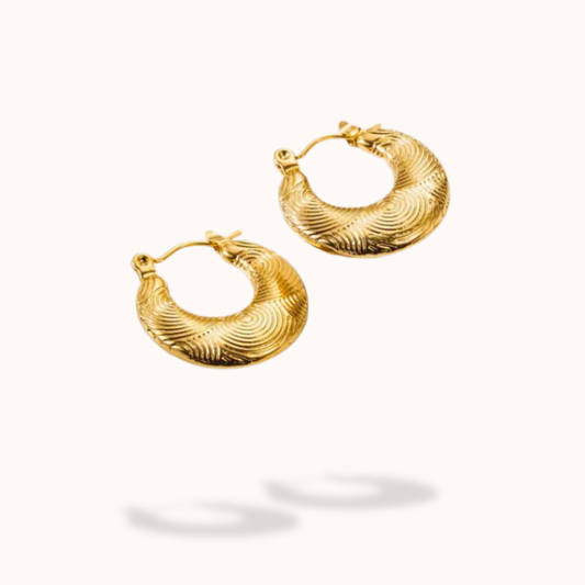 Pair of gold hoop earrings on a white background