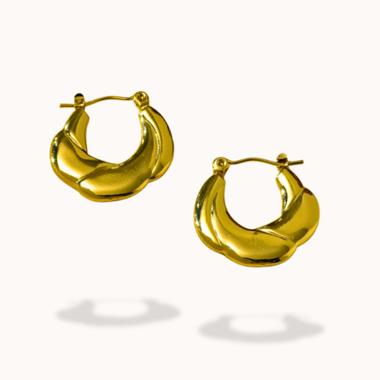 Gold hoop earrings on a white background