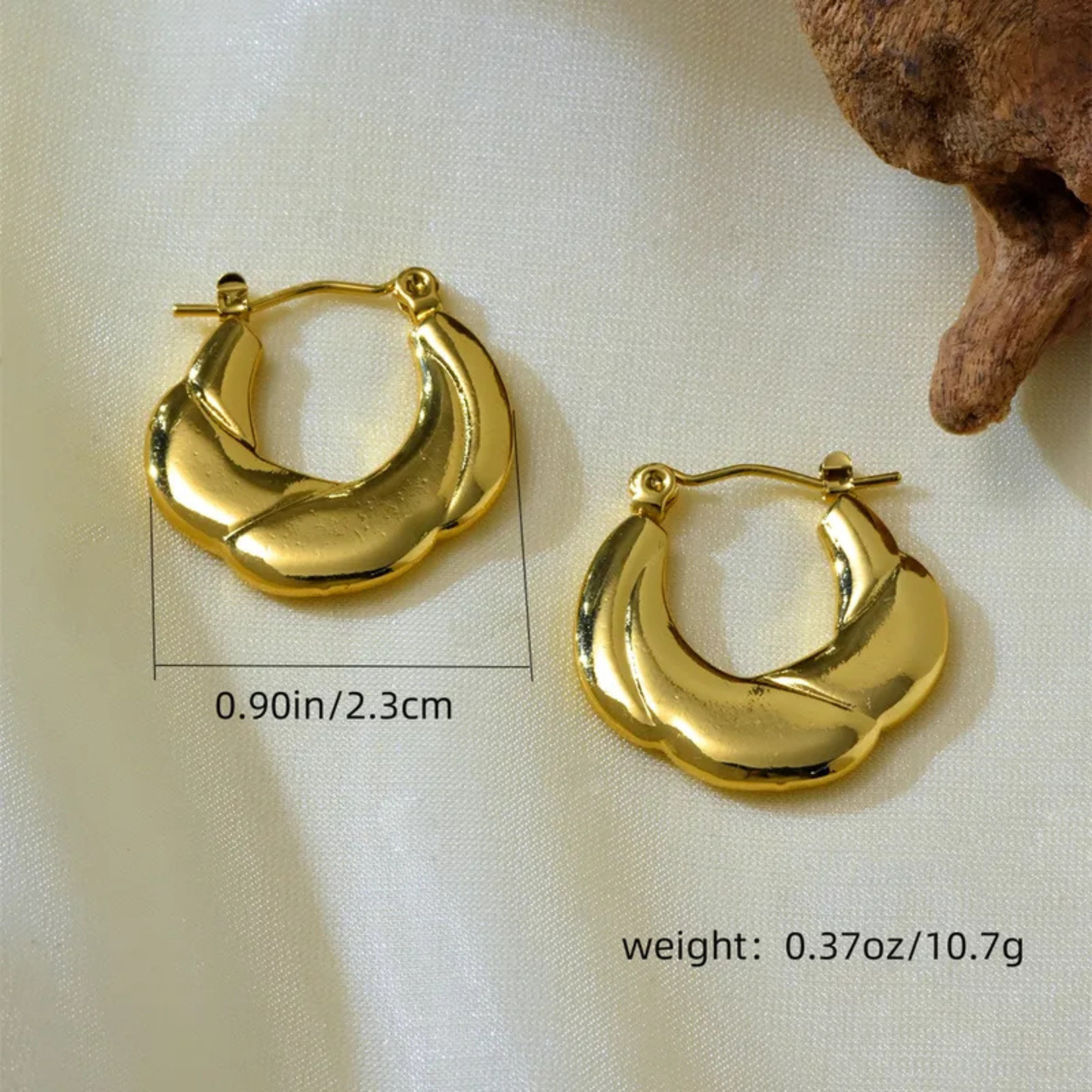 Gold hoop earrings on a light background with measurements and weight displayed.