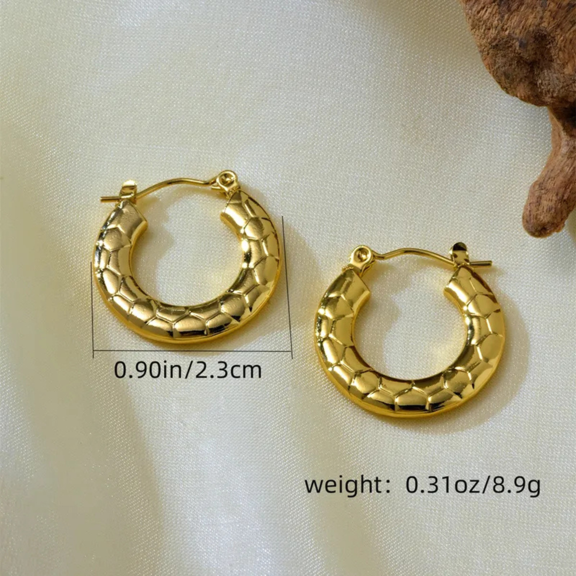 Gold hoop earrings with measurements and weight details on a light background