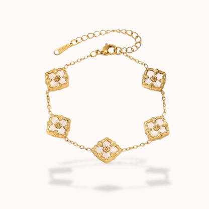 Gold bracelet with floral designs on a white background