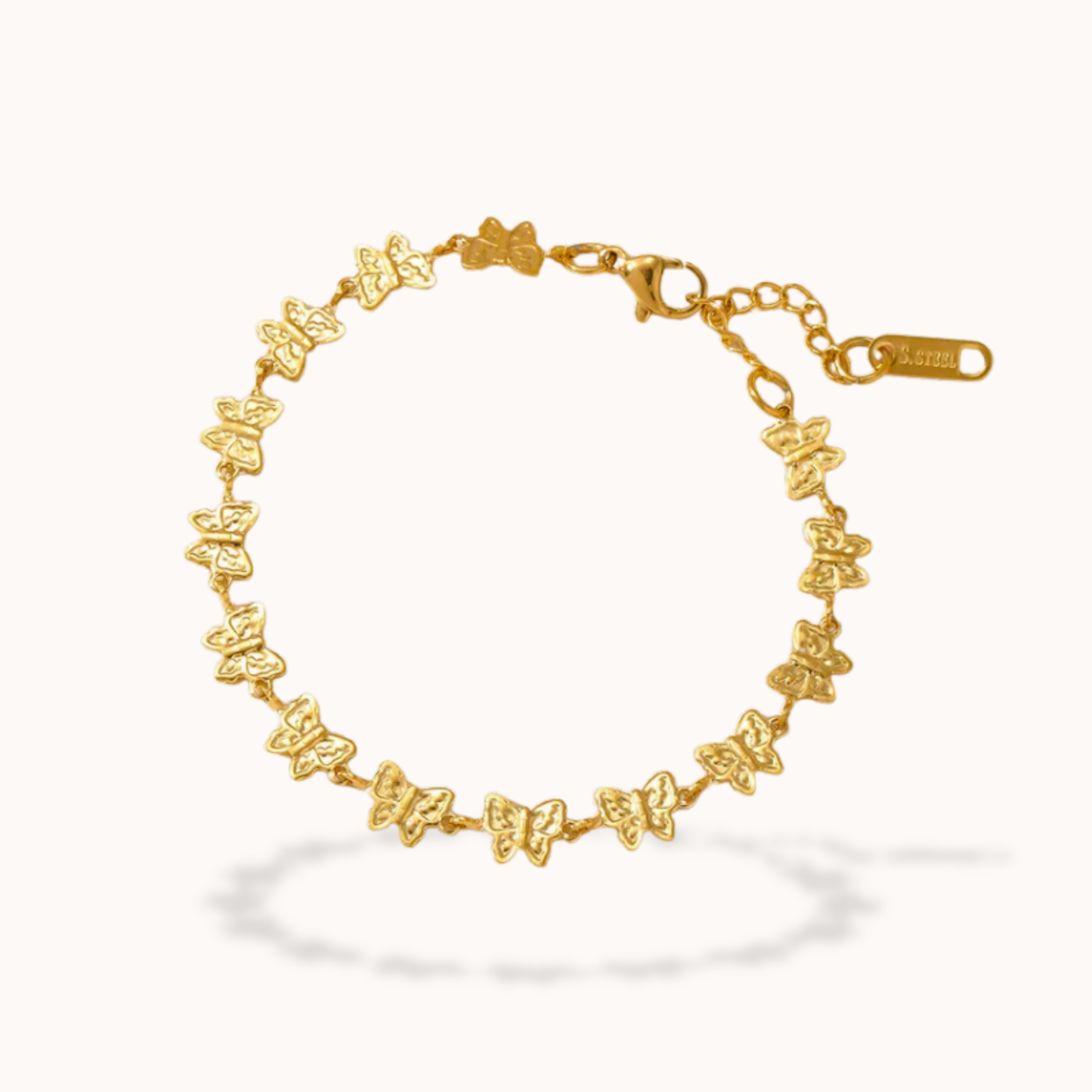Gold butterfly bracelet on a white background