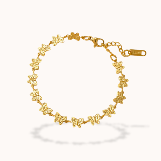 Gold butterfly bracelet on a white background