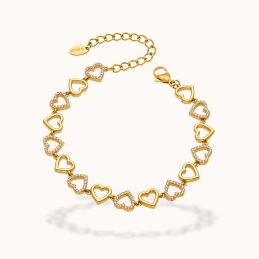 Gold bracelet with heart-shaped links on a white background