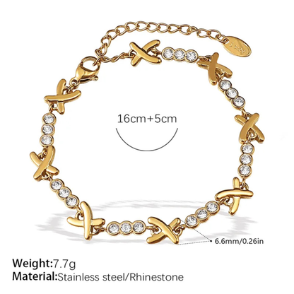 Gold bracelet with cross designs and rhinestones on a white background