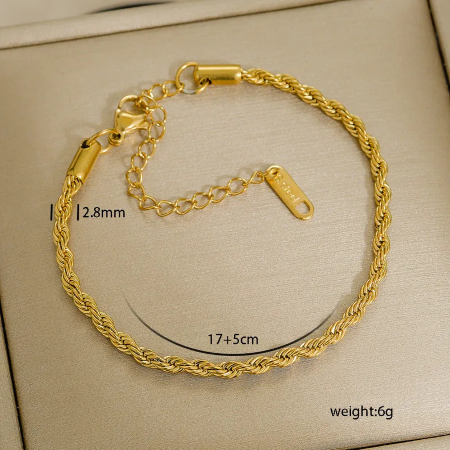 Gold bracelet on a beige background with measurements and weight displayed.