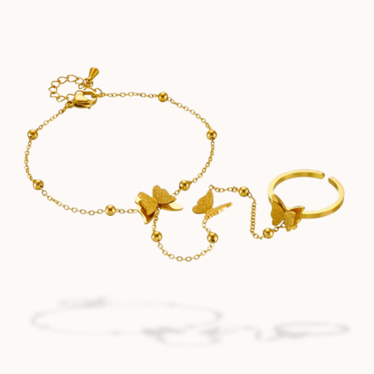 Gold bracelet and ring set with butterfly designs on a white background