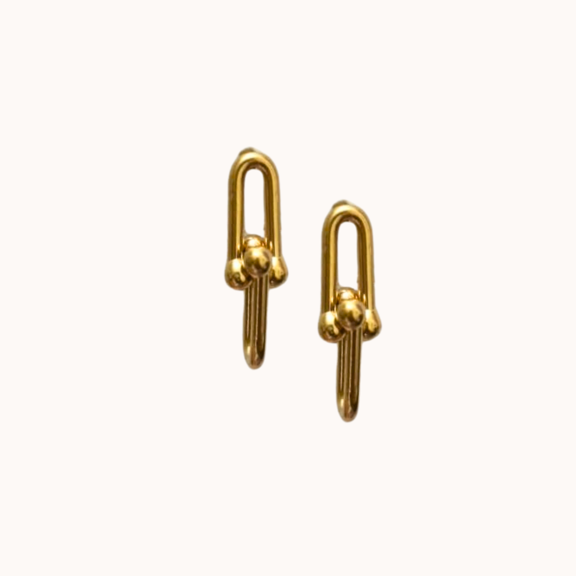 Pair of gold earrings on a white background