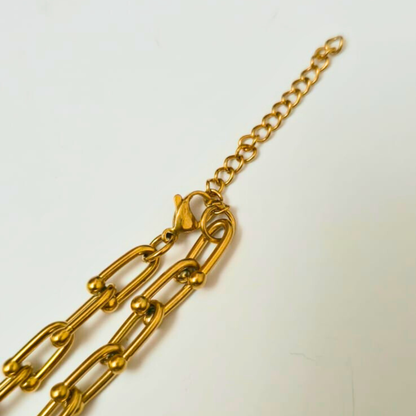 Gold chain bracelet on a white background