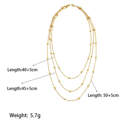 Gold necklace with measurements on a white background