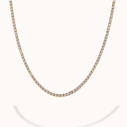 Gold necklace with small diamonds on a white background