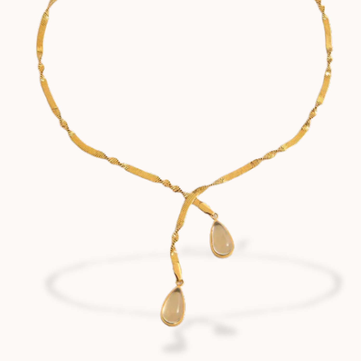 Gold necklace with teardrop-shaped pendants on a white background