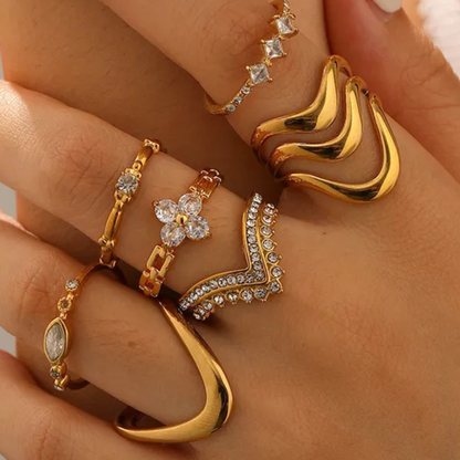 Gold rings with various designs on a hand