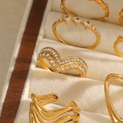 Gold rings with gemstones displayed in a jewelry box
