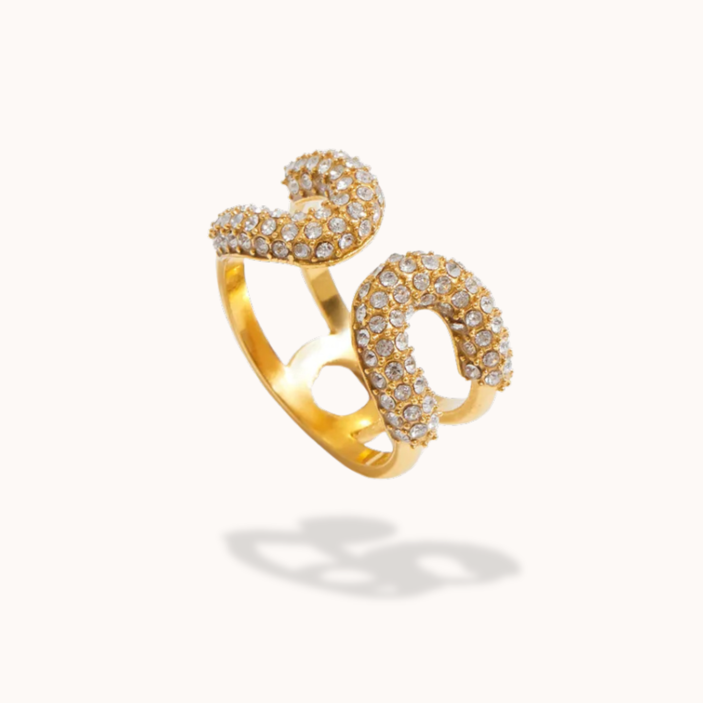 Gold ring with diamond accents on a white background