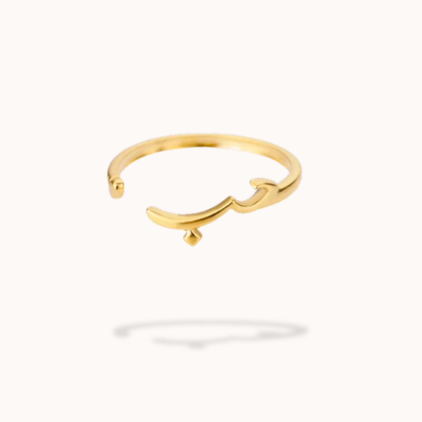 Gold ring with a unique design on a white background