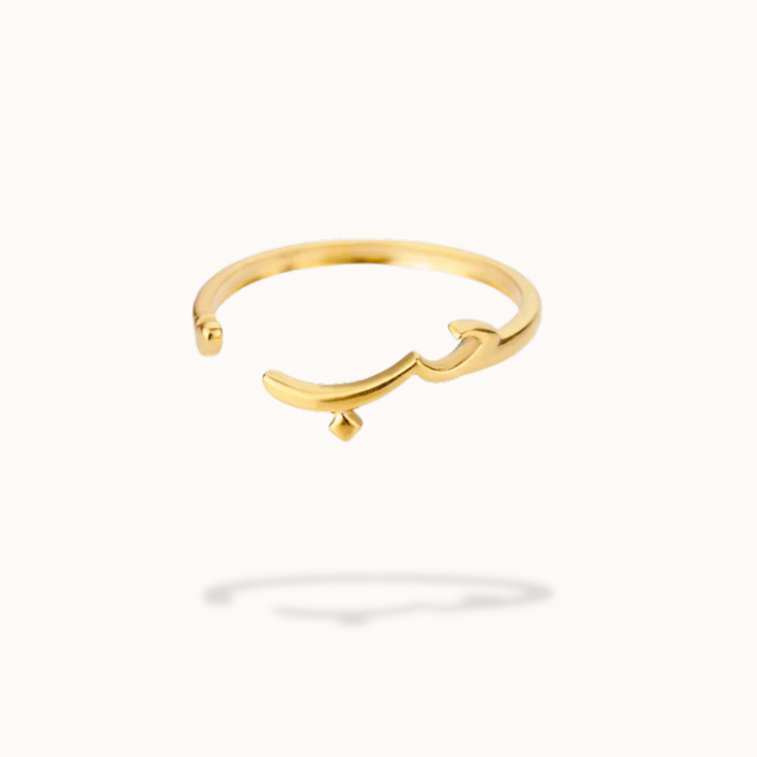 Gold ring with a unique design on a white background