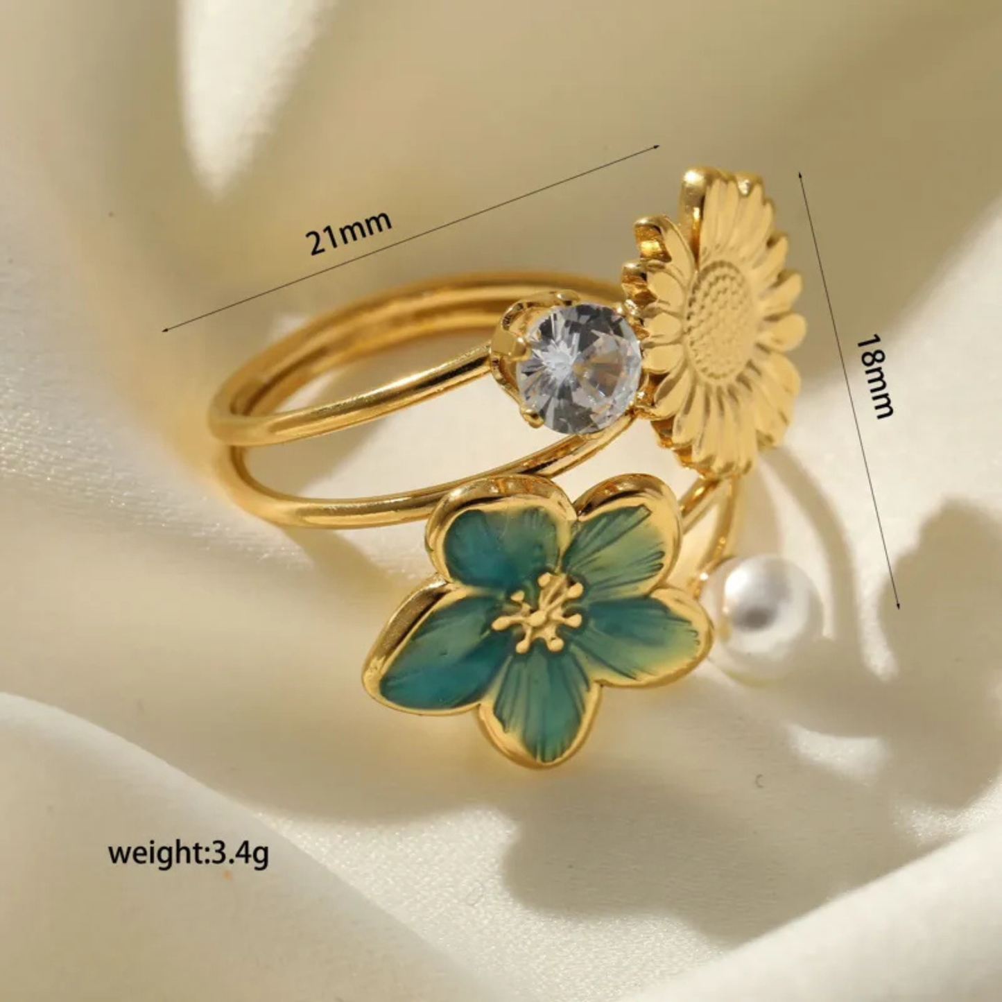 Gold ring with floral design and measurements on a beige background