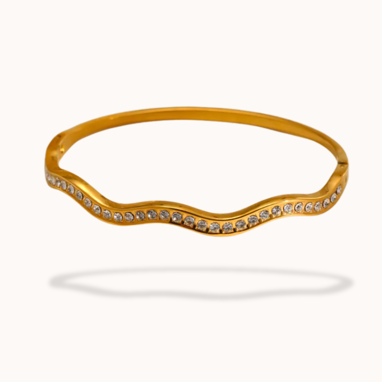 Gold bracelet with small stones on a white background