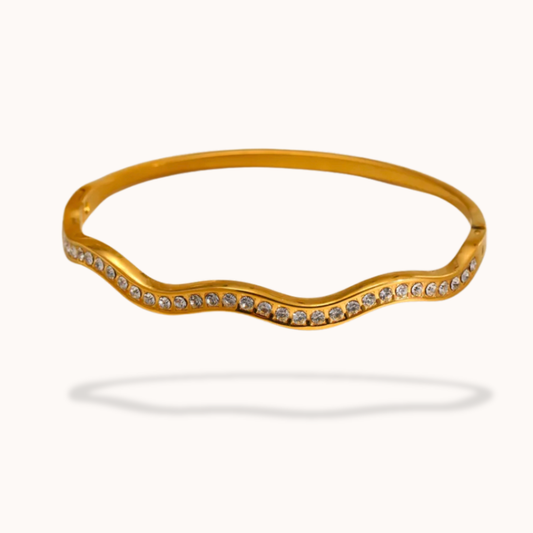 Gold bracelet with small stones on a white background