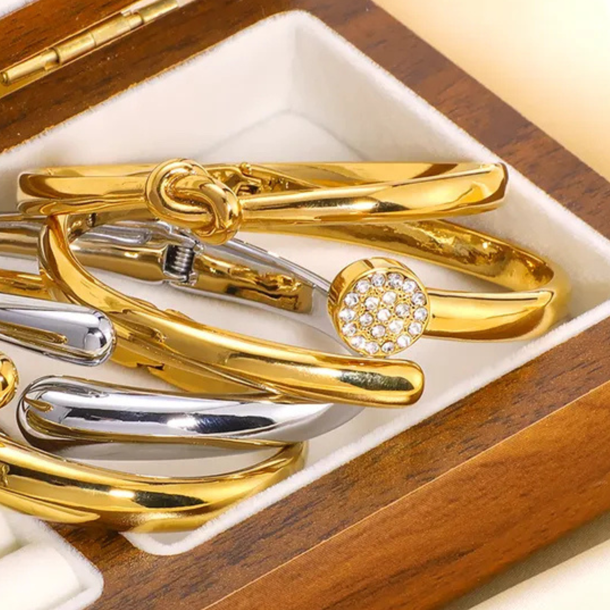 Gold and silver bracelets in a wooden box