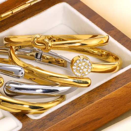 Gold and silver bracelets in a wooden box