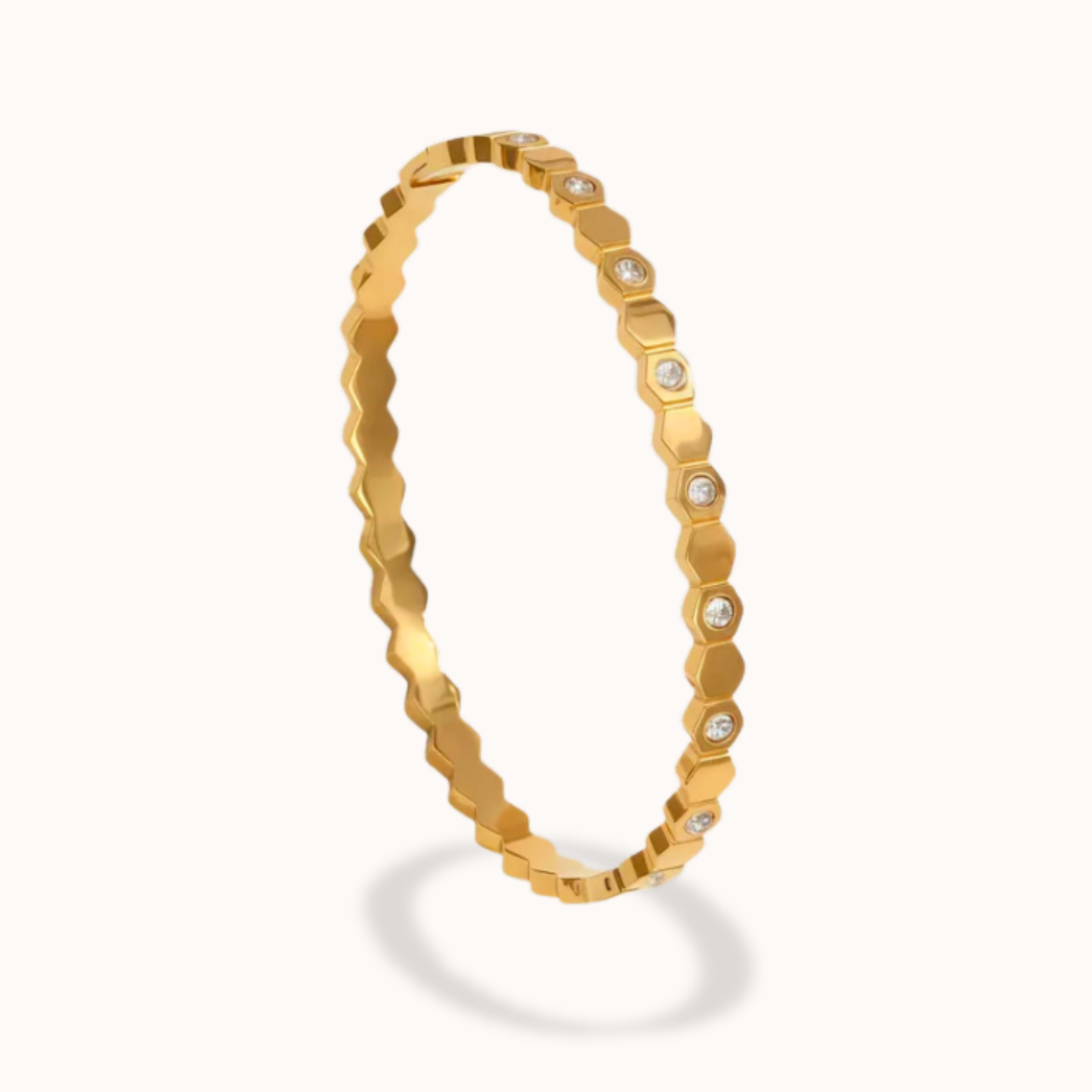 Gold bracelet with diamond accents on a white background