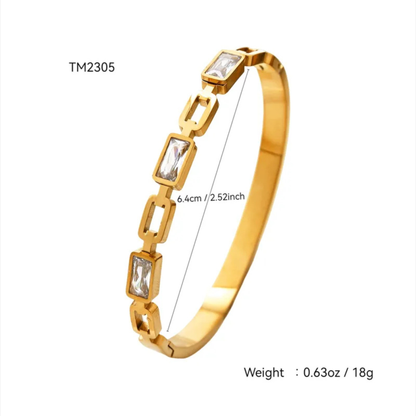 Gold bracelet with gemstones and measurements on a white background