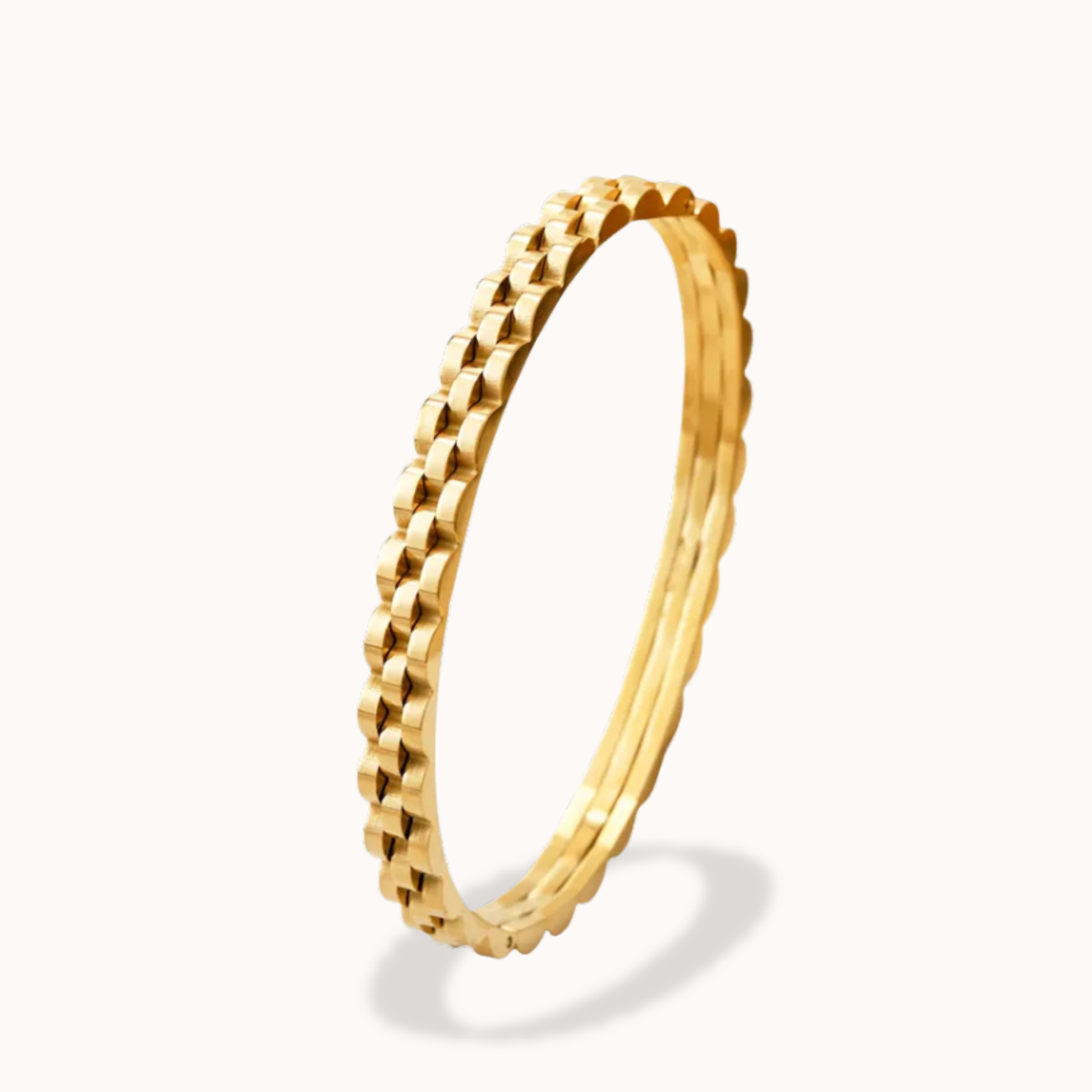 Gold ring with a textured design on a white background