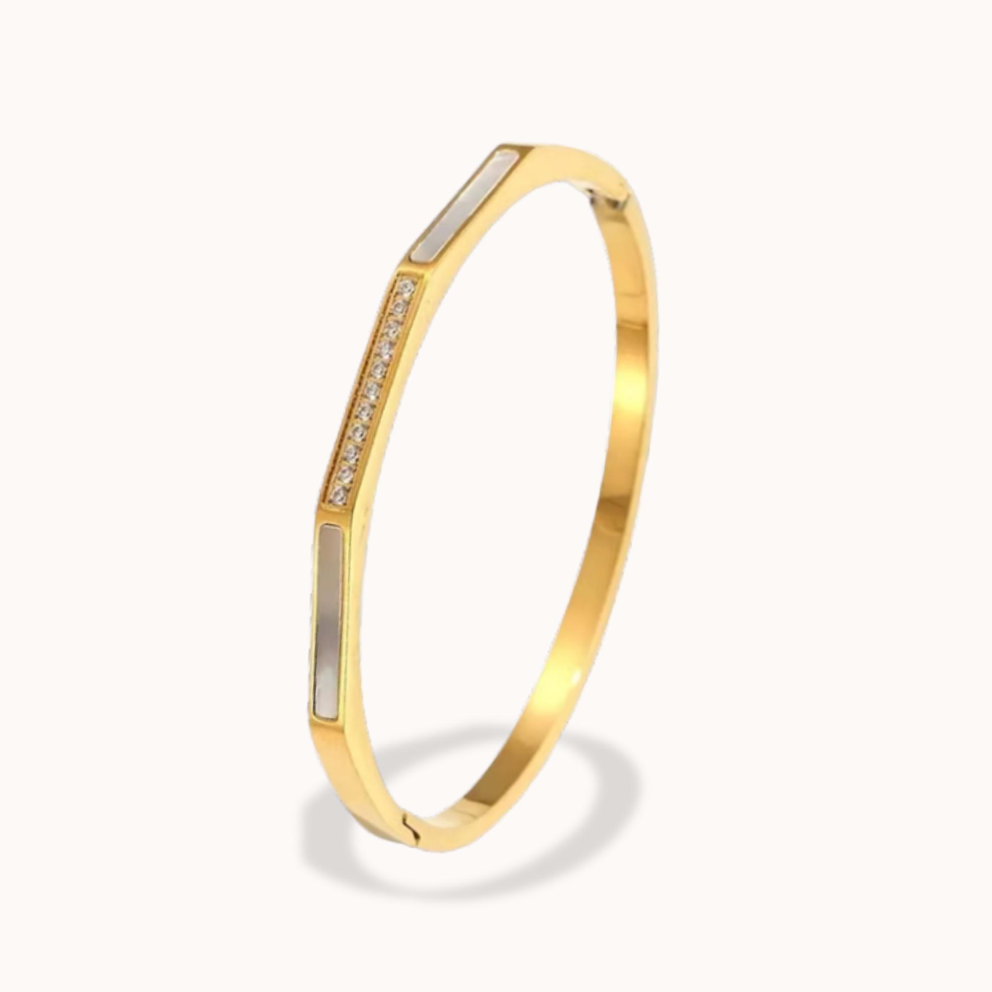Gold bracelet with embedded stones on a white background