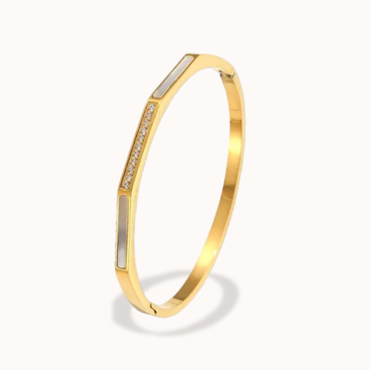 Gold bracelet with embedded stones on a white background