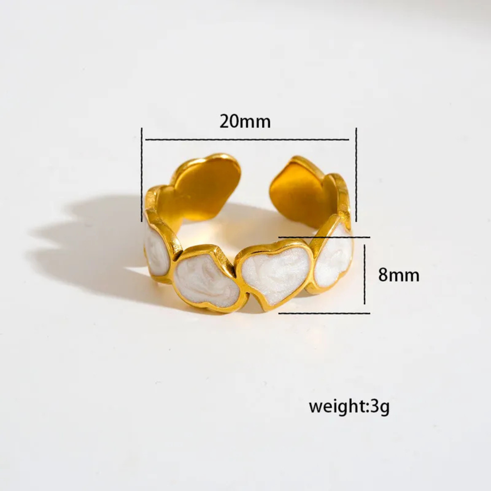 Gold ring with heart-shaped design and measurements on a white background