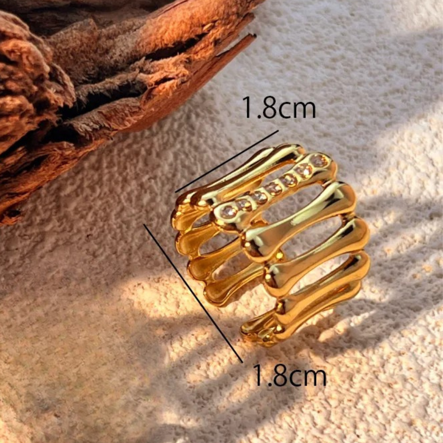 Gold ring with measurement details on a textured surface