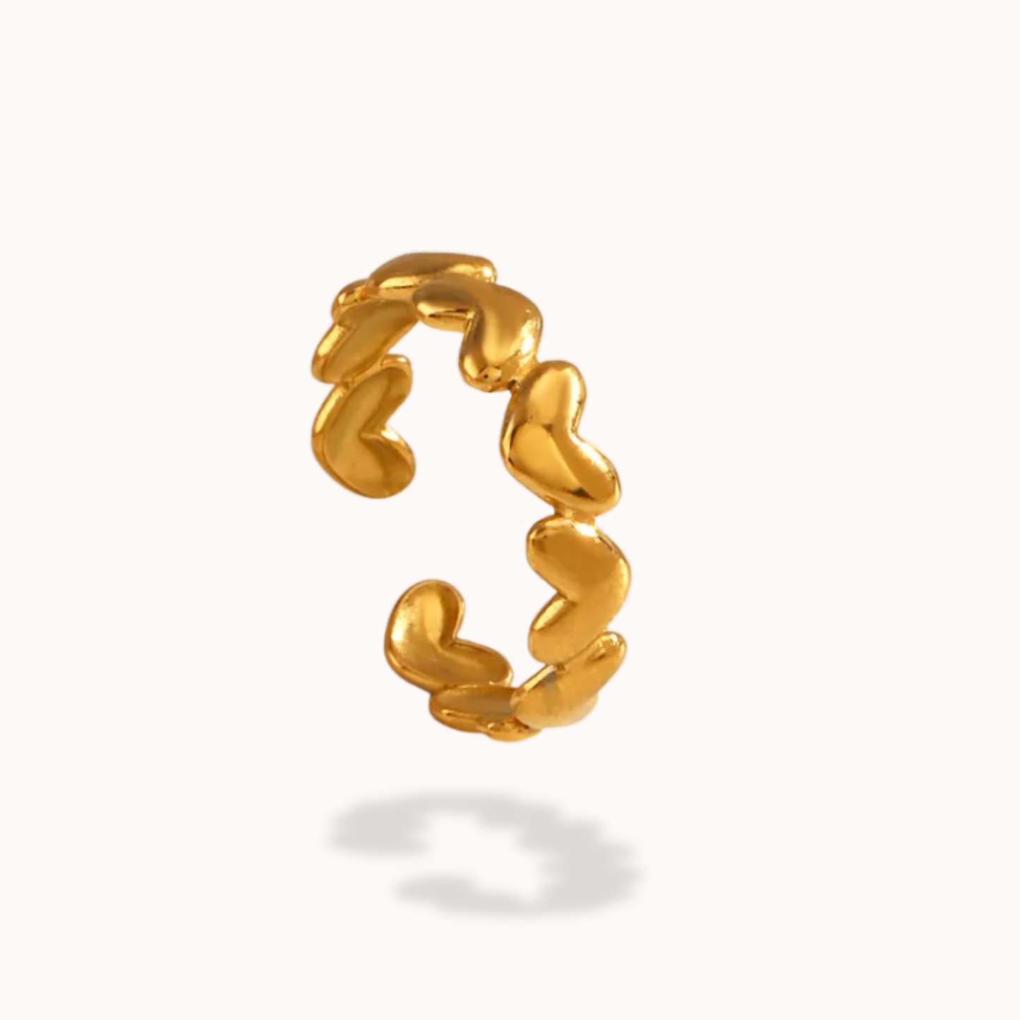 Gold heart ring on a white background