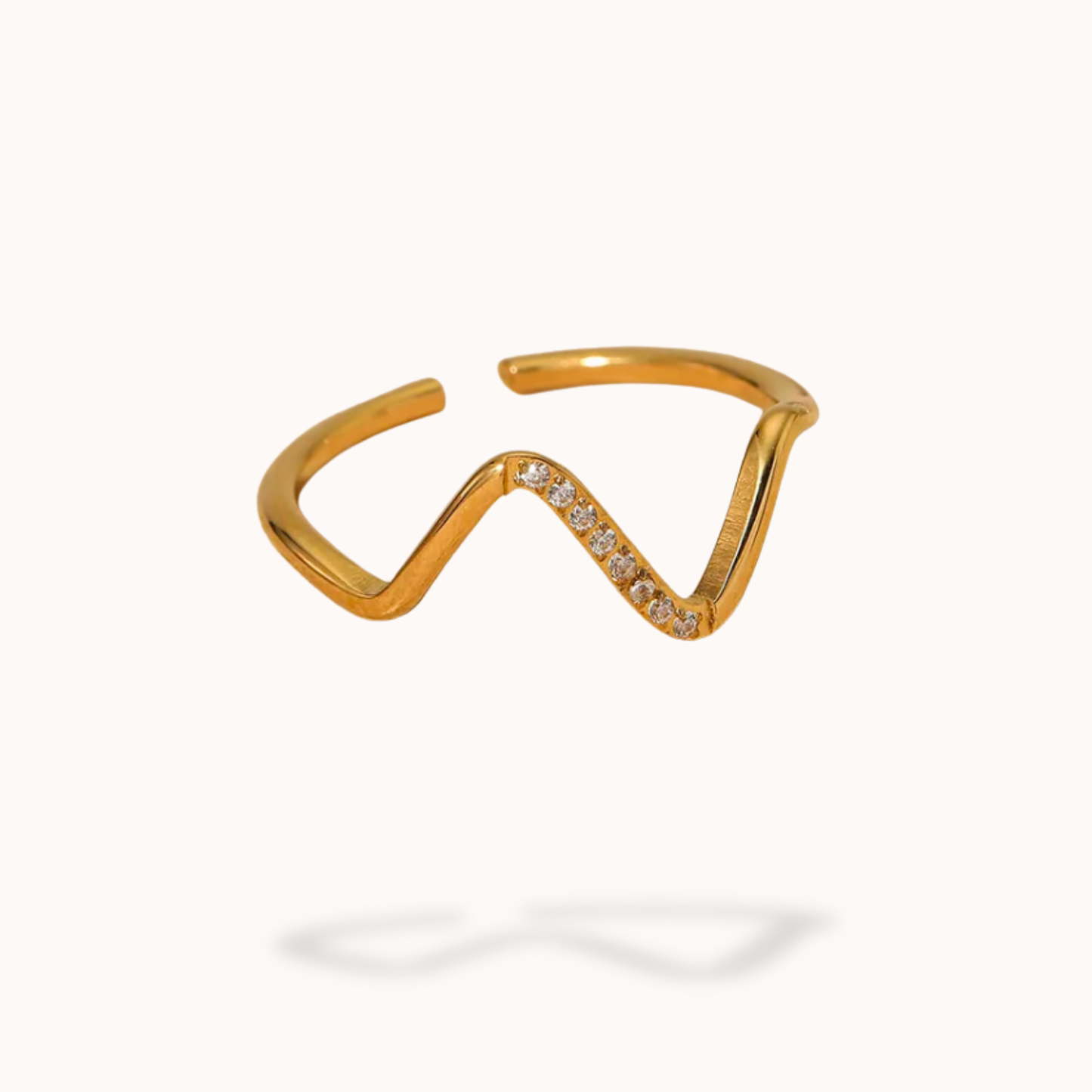 Gold ring with small diamonds on a white background