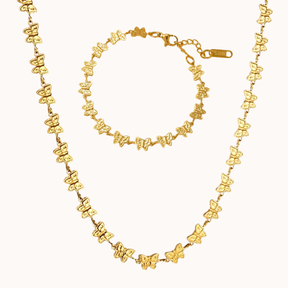 Gold butterfly necklace and bracelet set on a white background