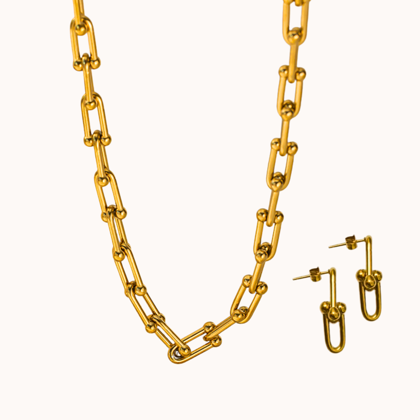Gold chain necklace and earrings on a white background