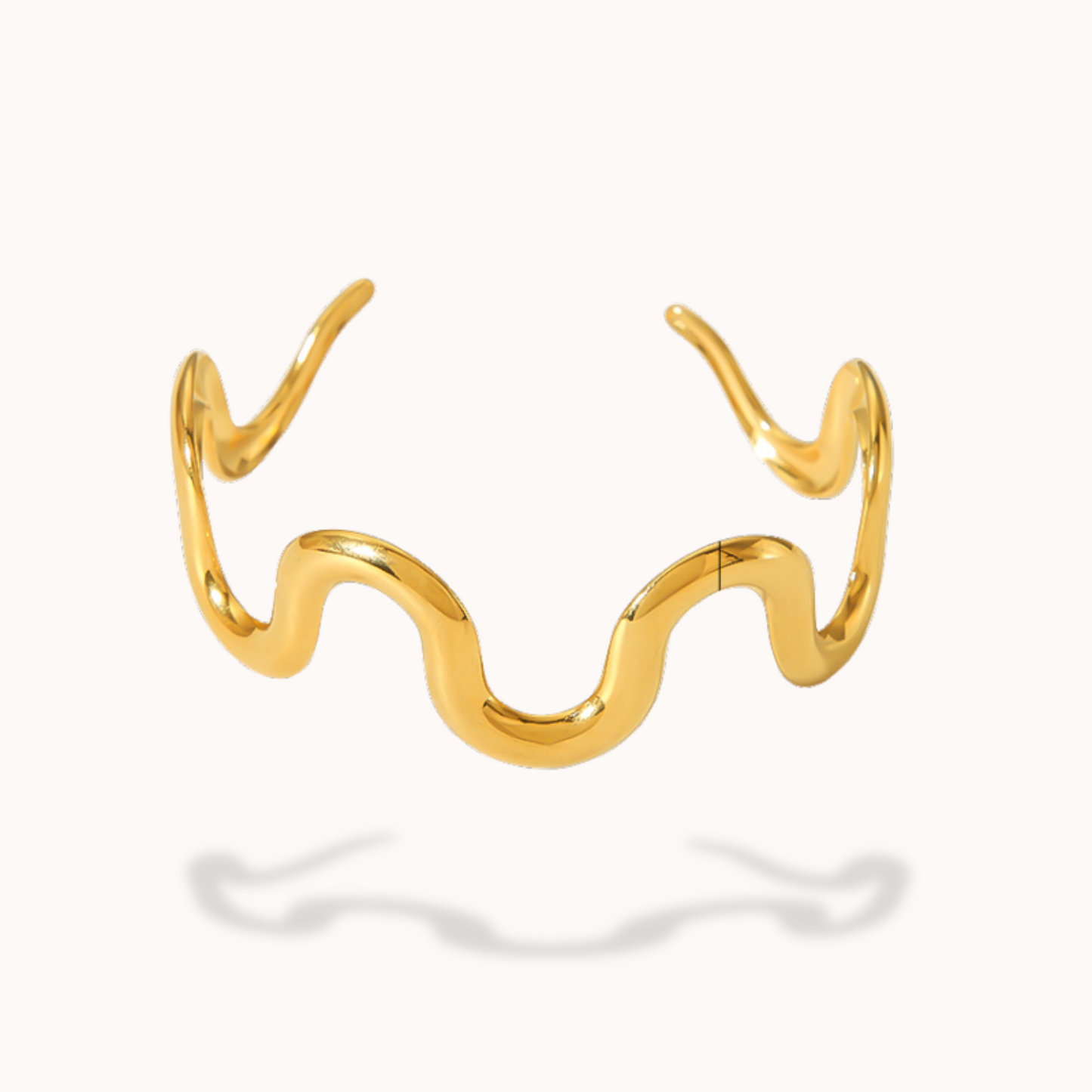 Gold wavy bracelet on a white background