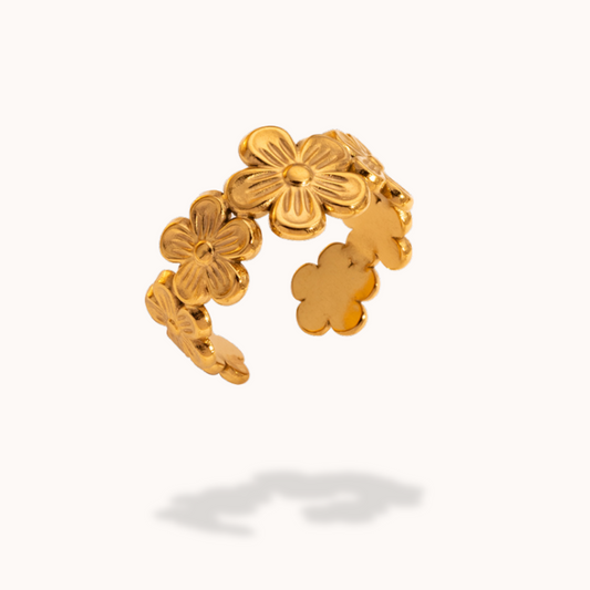 Gold floral ring on a white background