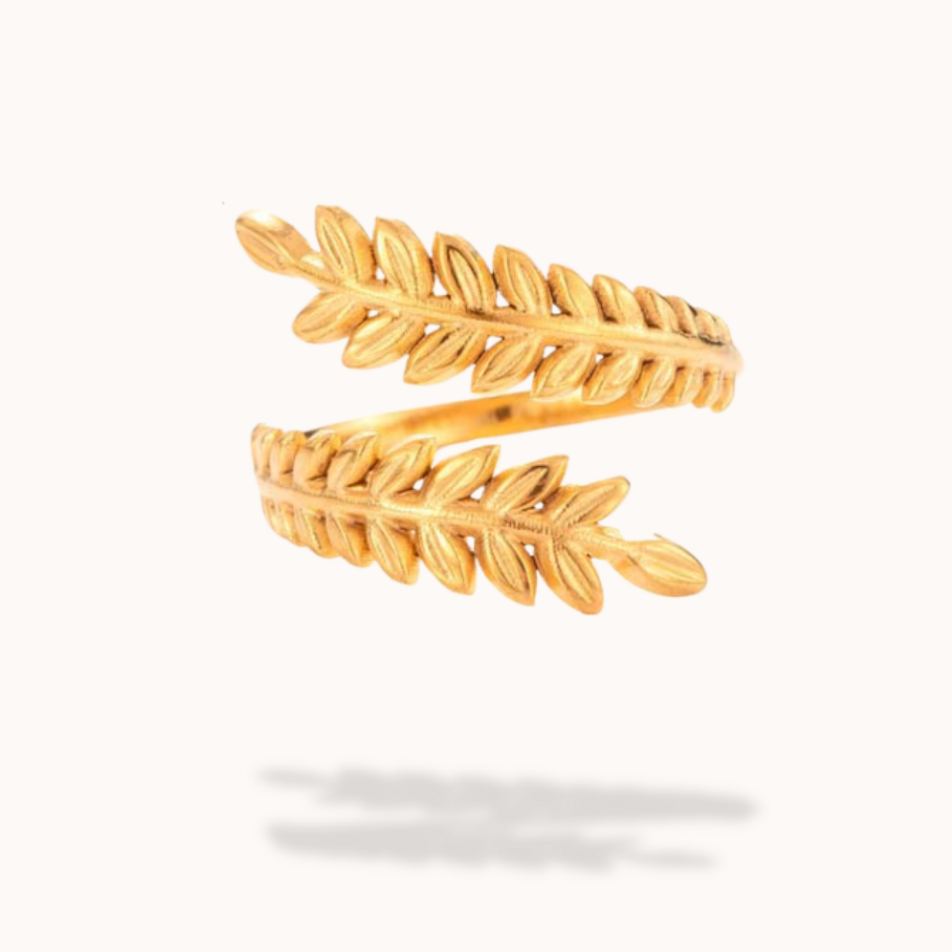 Gold leaf-shaped ring on a white background