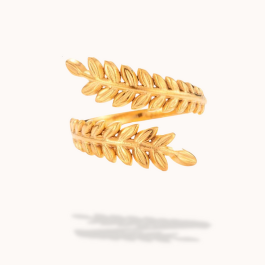 Gold leaf-shaped ring on a white background