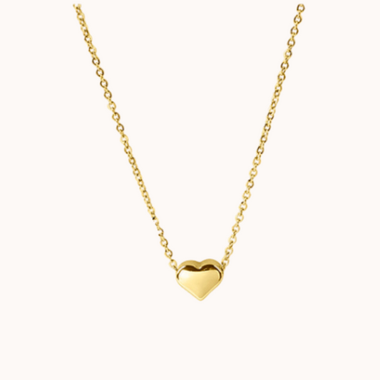 Gold heart-shaped pendant necklace on a white background