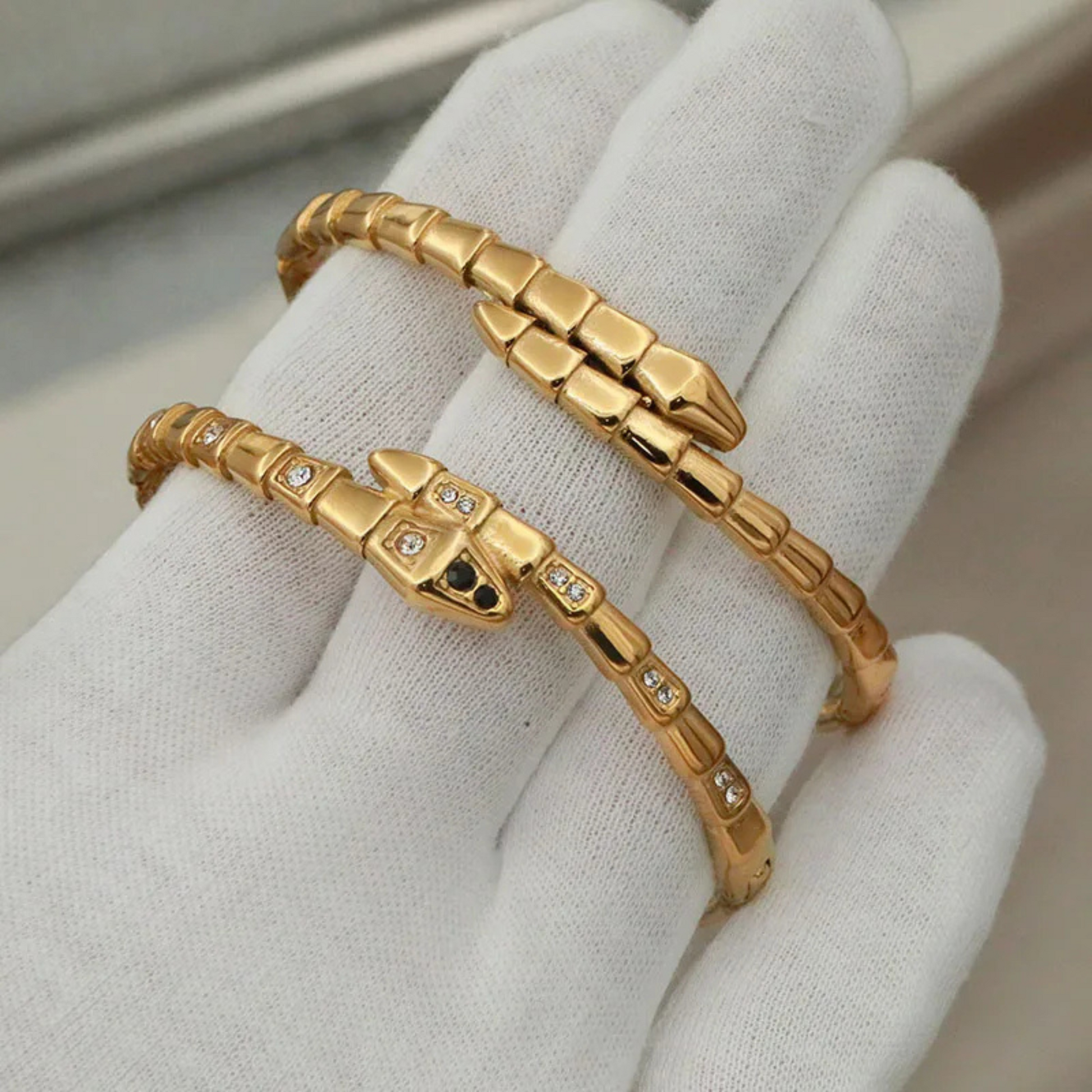 Gold bracelets on a white glove