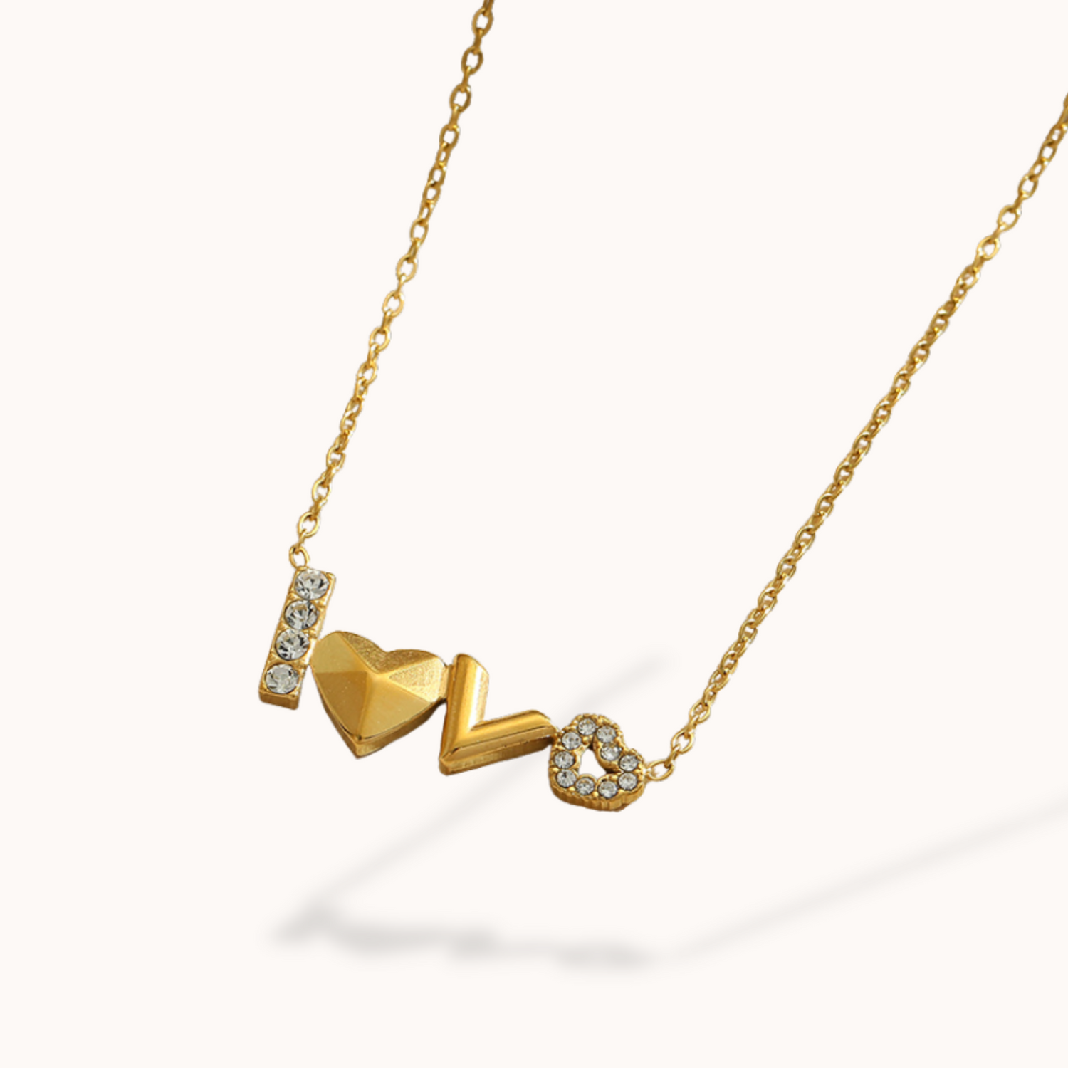 Gold necklace with heart-shaped pendants on a white background
