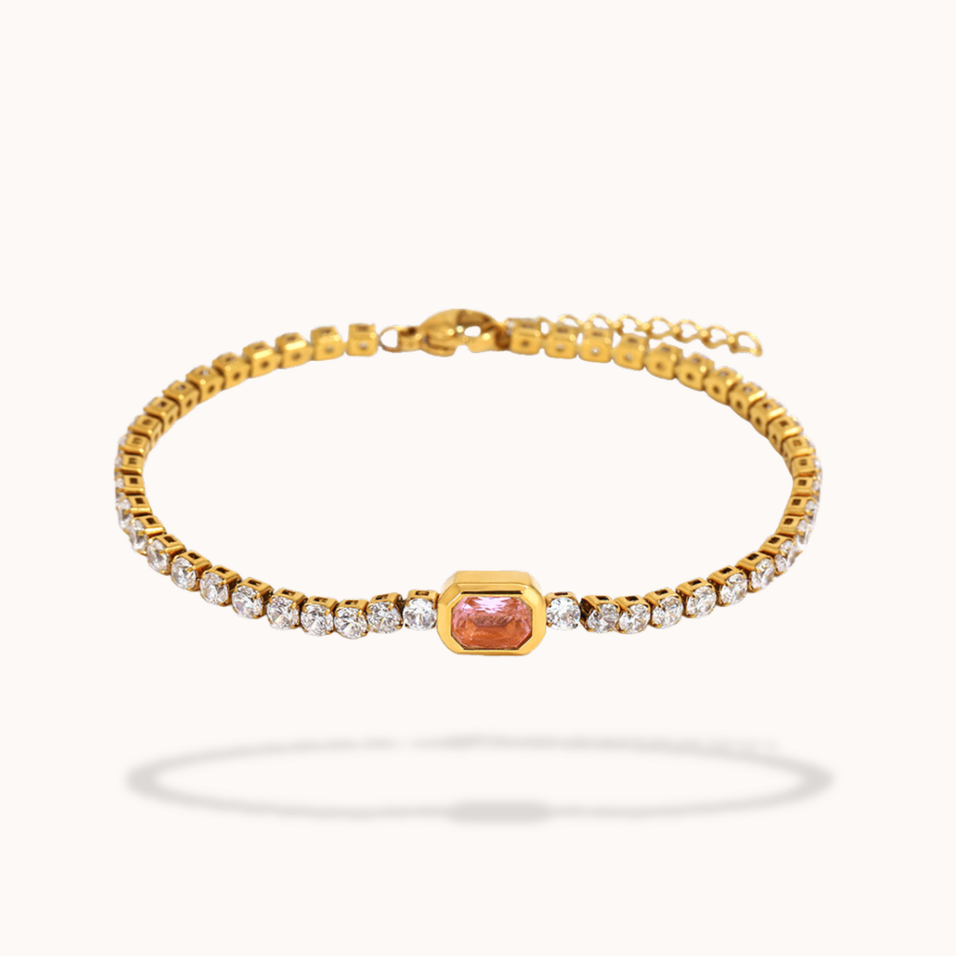 Gold Tennis bracelet with a pink gemstone and diamonds on a white background