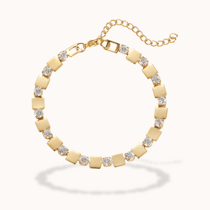 Gold bracelet with square links and clear stones on a white background