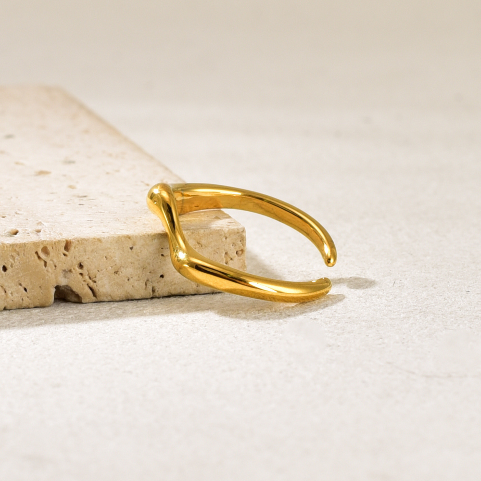 simple gold ring in beige background
