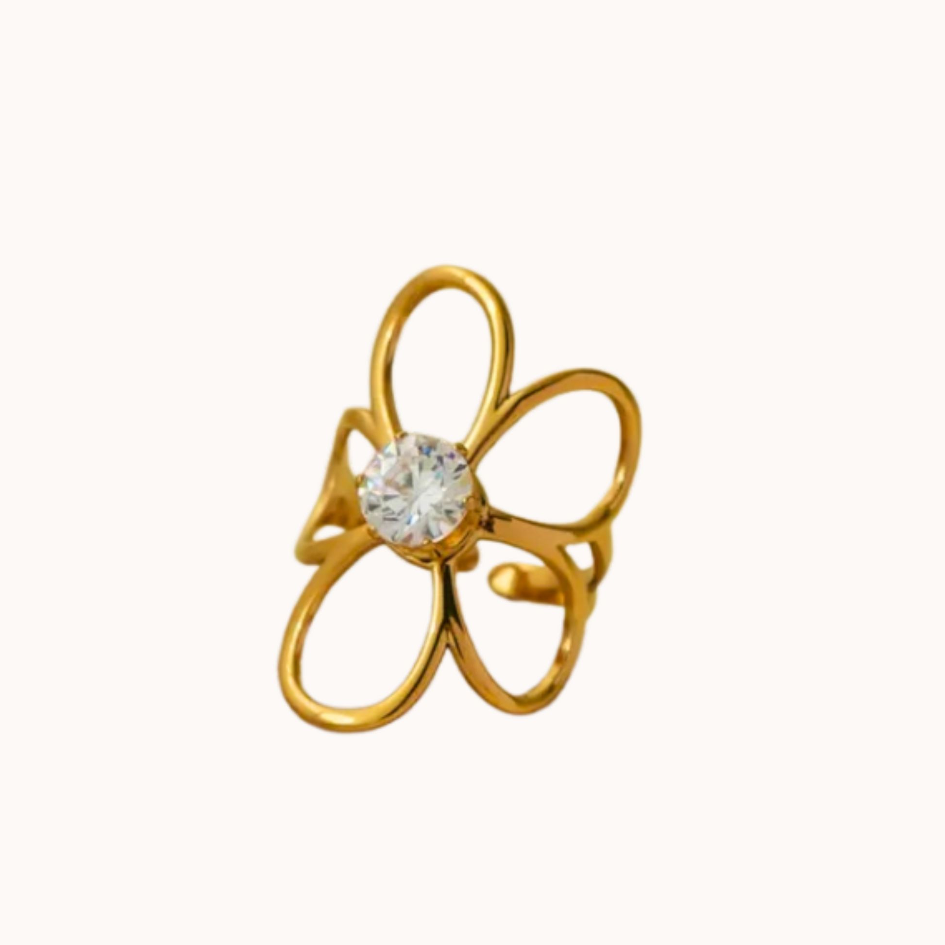 Gold flower-shaped earring with a clear gemstone on a white background